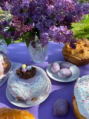 Happy Easter photography. Easter baking, eggs. Festive table. Lilac bouquet. Easter cake. Religion, traditions. Family holiday. Purple. Nature. Spring. Homemade baking.