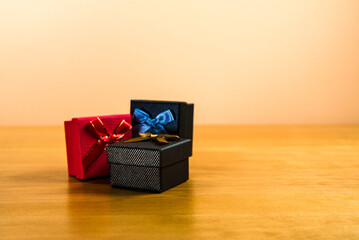 Gift Boxes with Decorative Ribbons on a Wooden Surface in Warm Lighting
