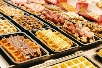 Filled Belgian waffles on display in a shop window.