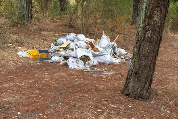 Garbage polluting an abandoned forest area threatening the environment