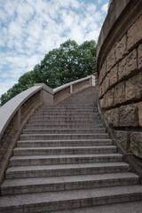 A low-angle perspective looking up the wide, majestic stone staircase at the historic Wasserturm in Mannheim, Germany.