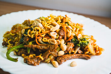 Delicious Japanese yakisoba stir-fried noodles with fresh vegetables on a plate. Savory, glossy and perfectly cooked. Ideal for Asian food content.