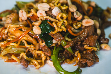Delicious Japanese yakisoba stir-fried noodles with fresh vegetables on a plate. Savory, glossy and perfectly cooked. Ideal for Asian food content.