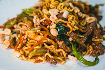 Delicious Japanese yakisoba stir-fried noodles with fresh vegetables on a plate. Savory, glossy and perfectly cooked. Ideal for Asian food content.