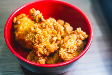 Golden brown, crispy Japanese karaage chicken pieces served in a bowl. Juicy, succulent interior with a crunchy coating. Perfect for Asian food concepts.