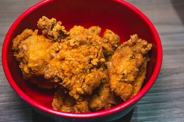 Golden brown, crispy Japanese karaage chicken pieces served in a bowl. Juicy, succulent interior with a crunchy coating. Perfect for Asian food concepts.