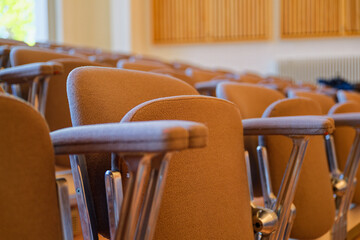 Concert hall rows with gray seats and defined armrests