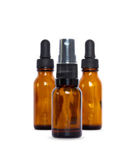 Three amber glass bottles, featuring both dropper and fine mist spray caps. Ideal for cosmetic, aromatherapy, or skincare product mock-ups. Clean studio shot with copy space