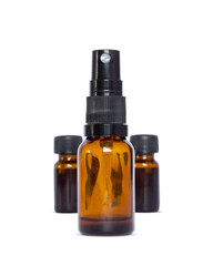 Close-up of an amber glass spray mist bottle with two smaller vials in the background. Perfect product mock-up for cosmetics, toners, perfumes, or essential oil room sprays.