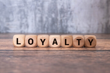 CUSTOMER LOYALTY text on a blue card on a notebook