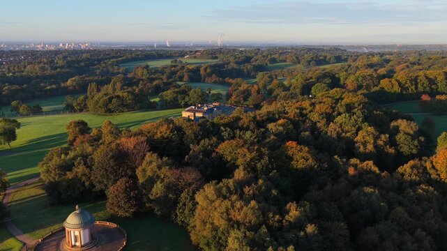 Aerial sunrise video of Heaton Park and the rotunda Temple in Prestwich with Manchester skyline in the distance.