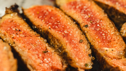 Juicy sliced steak cooked medium rare, seasoned with coarse barbecue salt. Perfect for food blogs...