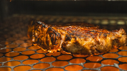 Perfectly grilled, golden brown beef steak cooking on charcoal grill. Succulent and sizzling, ideal for food blogs and barbecue content.