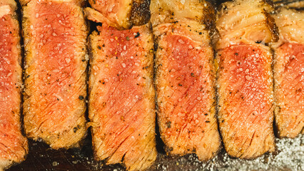 Juicy sliced steak cooked medium rare, seasoned with coarse barbecue salt. Perfect for food blogs and restaurant menus.
