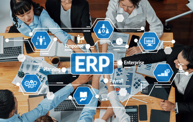 High-angle view of a diverse team engaged in ERP strategy planning in a modern office. Focus on teamwork, technology, and effective business processes in action. Amity