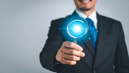 Futuristic business concept with holographic magnifying glass icon and businessman hand interaction