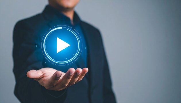 Holographic play button icon in businessman hand symbolizing digital innovation - Powered by Adobe