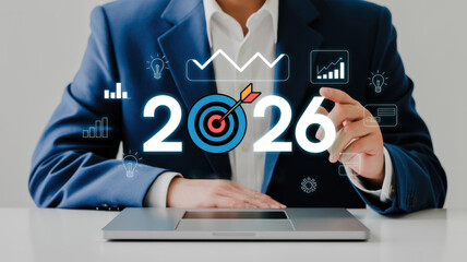 A person with the year 2026 and business icons, representing future goals, planning, and success in the business world