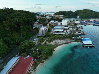 Aerial view of Malakal Island and Malakal Harbor in Palau during sunset, tropical coastline with harbor, ships and waterfront buildings. Ngemelachel