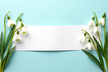 Springtime greeting card and invitation mockup with delicate snowdrop flowers framing a blank white paper banner.