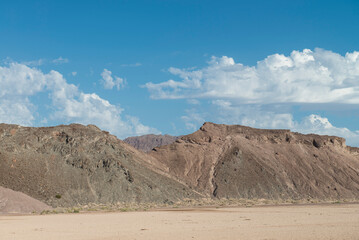 Baja California desert on the highway from Mexicali to San Felipe MEXICO on a sunny summer morning with a view of the mountains and a blue sky with clouds