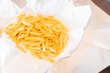 Serving of hot chips with chicken salt wrapped in white paper from Australian takeaway shop