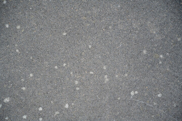 A grey and white background with a few small dots
