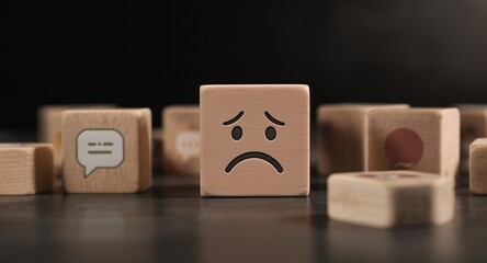 Wooden Blocks Depicting Sad Emoji and Communication Icons