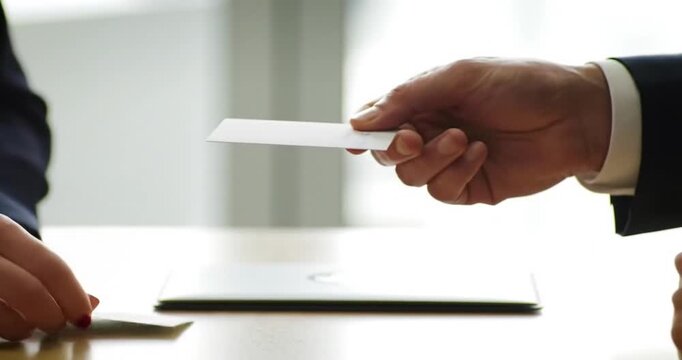 Business professionals exchanging contact information indoors