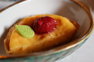 Egg tart topped with raspberry