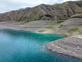 Aerial view of Toktogul water reservoir and Tien Shan mountain range in Kyrgyzstan, Central Asia.