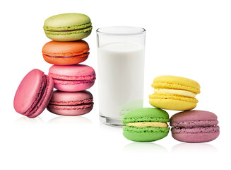 colorful macarons and a glass of milk on a dark background