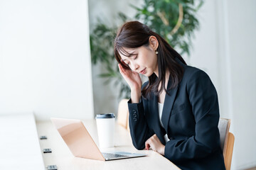 頭をおさえる女性