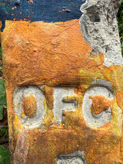 A piece of concrete with the letters OFC painted on it