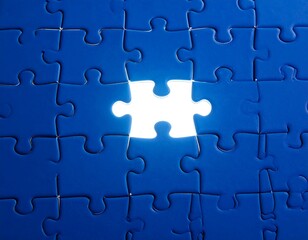 A single white jigsaw puzzle piece missing from a blue puzzle