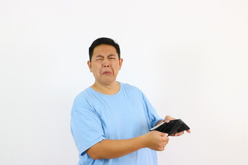 Sad face asian Man Looking at Empty Wallet with Disgust