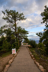 Bright Angel Point trail closed for maintenance, work zone ahead sign on paved path and barricade at trailhead, north rim Grand Canyon National Park, Arizona

