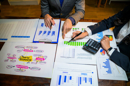 Business partners analyzing company financial data and strategy - Powered by Adobe