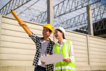 Engineers discussing construction plan at building site