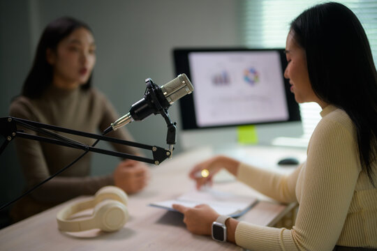 Women recording podcast content live in studio