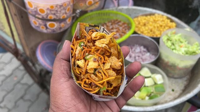 Ghoti gorom, a road side mixture with onion, hog plum prepared in Kolkata, India