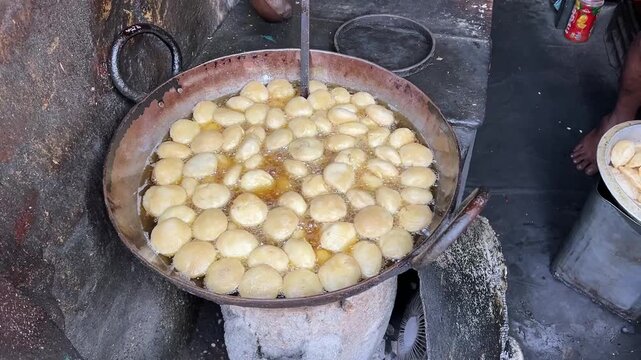 Dal kachori getting fried in charcoal stove in a road side shop in India