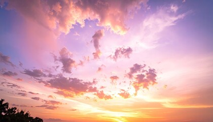 Colorful Sunset Sky with Orange and Purple Hues Dramatic Cloud Formations and Silhouette of Trees in Lower Frame Beautiful Tranquil Scene