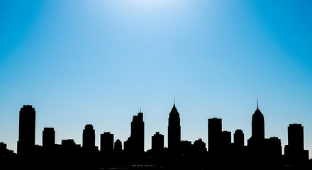 Obraz premium Cityscape Silhouette Against Light Blue Sky Background