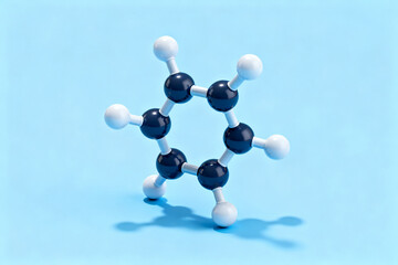 3D molecular model of benzene ring with black and white atoms on blue background