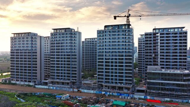 Aerial shot of modern high rise residential apartment buildings under construction in a new real estate development zone
