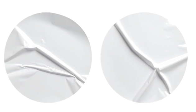 Two circular, wrinkled white stickers