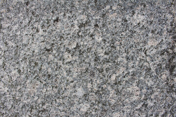 Rough surface of gray rock wall close up background. Rugged rock wall texture.