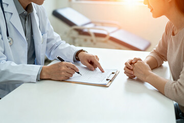 Doctor discussing medical records with a patient during a consultation in a clinic