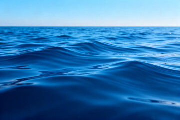 Calm blue ocean waves under a clear sky